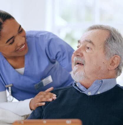 caretaker helps the elderly man