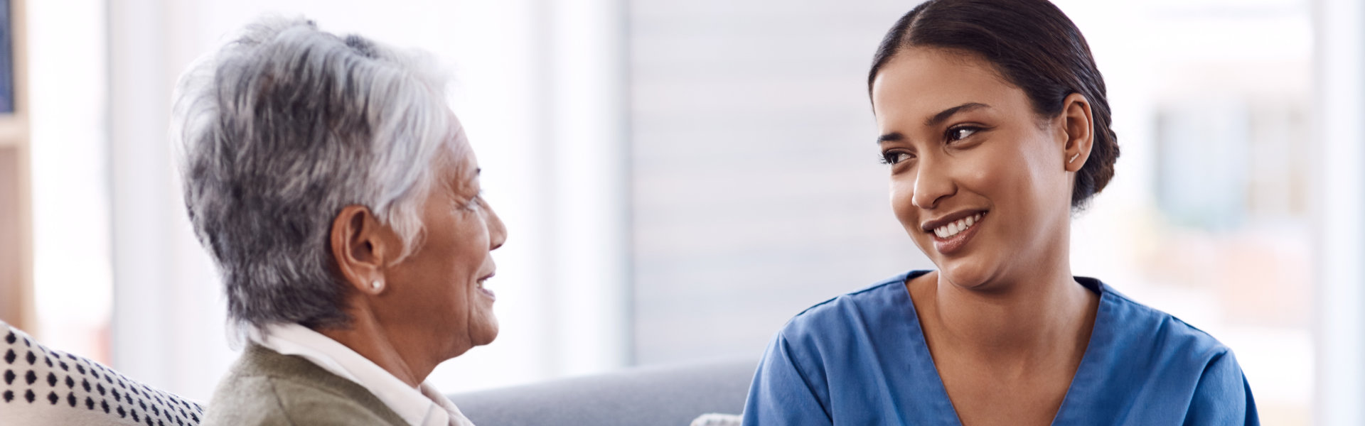 elderly woman and caretaker talking